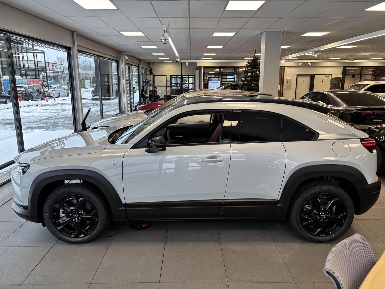 Mazda MX-30 e-SkyActiv R-EV 170 Nagisa , Demovoordeel ¤ 9.250-, Half Leder, Bose, Adap.Cruise, Navi, Apple Carplay, Clima, Camera, PDC, HUD, Stuur/Stoelverwarming, 18" LMV