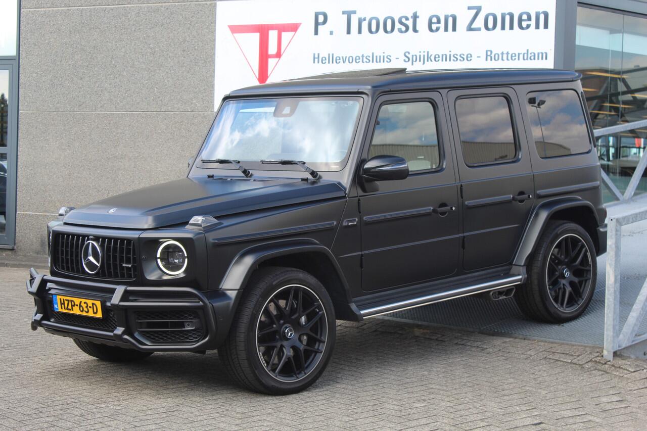 Mercedes-Benz G-KLASSE 63 AMG Manufaktur/Night pakket/Magno matt/Panoramadak/Burmester/Sfeerverlichting/Entertainment schermen/Akrapovic/AMG active ride control/Elektrisch verstelbare stoelen met memory + massage/Stoel verwarming + koeling/360° camera/voorruitverwarming/IWC/Ala